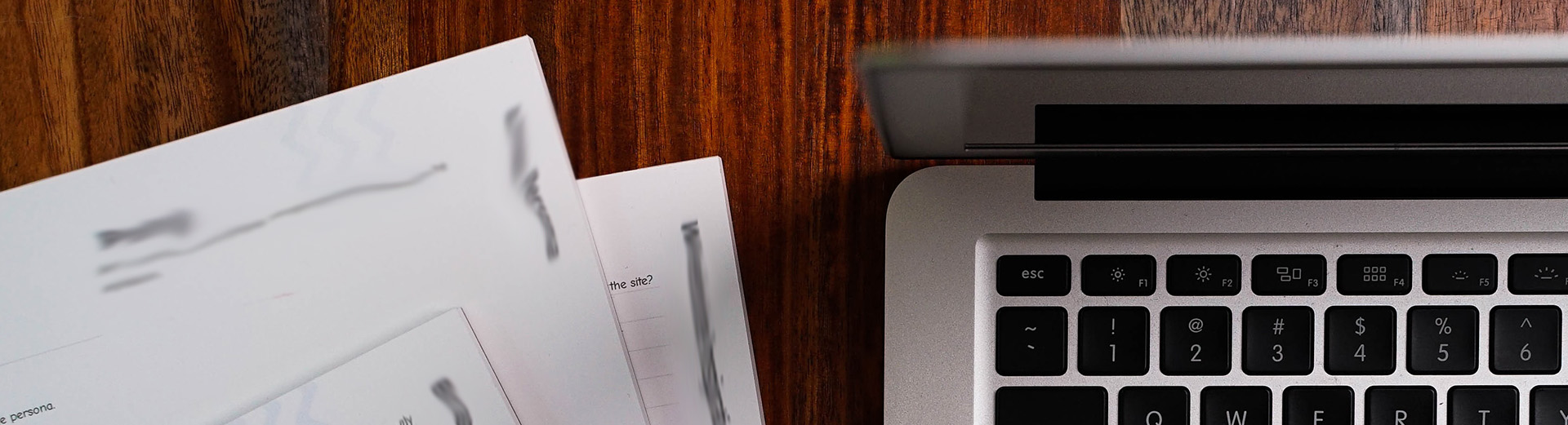 Laptop + a blurry document. Background image for the hero on the page.